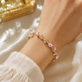 Pink Crystal Wave Bracelet – Elegant Gold-Tone Jewelry